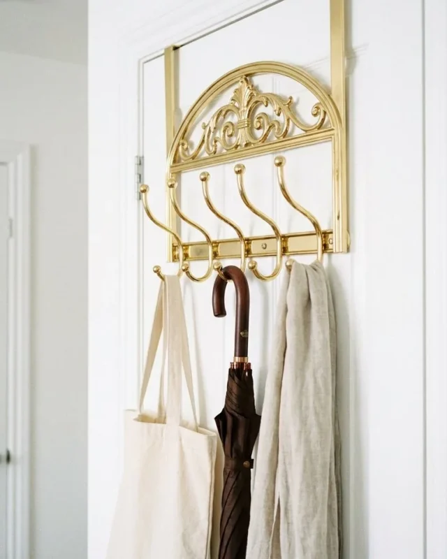 Gold metal door hanger rack used for decorative purposes over the door