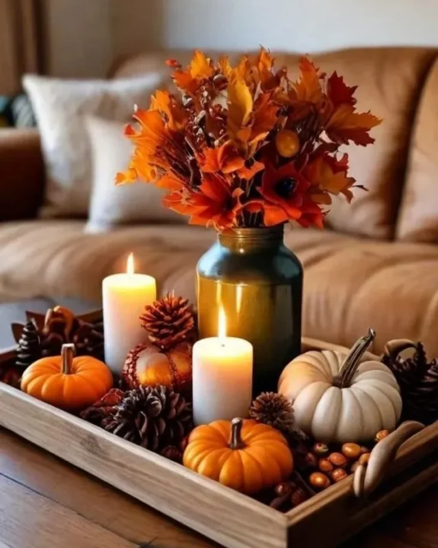 Cozy fall coffee table decor featuring trays, velvet pumpkins, and candles