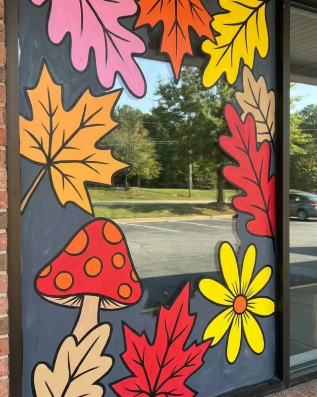 Colorful fall window painting for cafes and stores, showcasing autumn themes.
