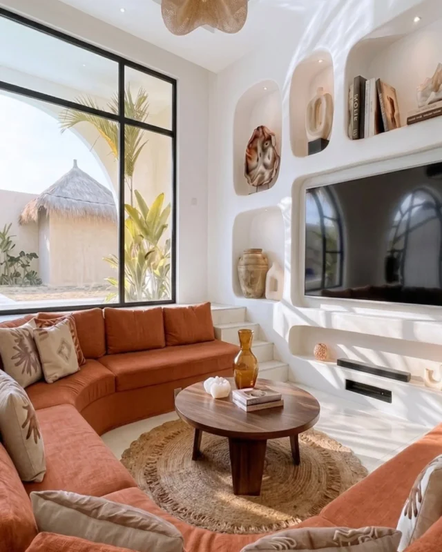 Modern Mediterranean living room featuring arched windows and cozy sunken seating.
